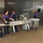 MX Automatic Food Tray Sealer with Accumulator Table in use at a school