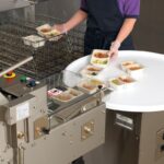 Oliver 2218 Rotary Accumulator Table with MX-2 1908 and food trays