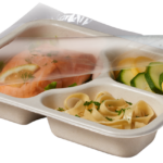 Compostable Tray with Salmon Zucchini and Noodles, with film being peeled off
