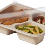 Compostable food tray with Chicken Tenders Beans Potatoes, with film peeled back