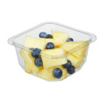 Clear plastic food tray with pineapples and blueberries