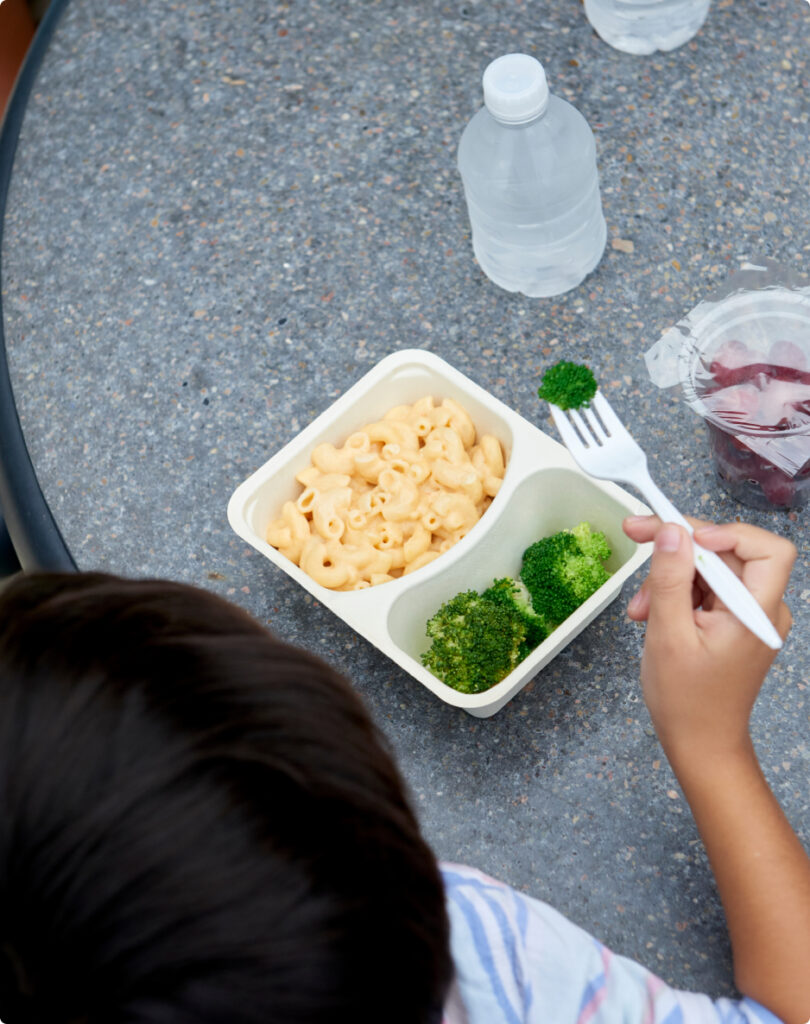 Student enjoying a sealed tray lunch.