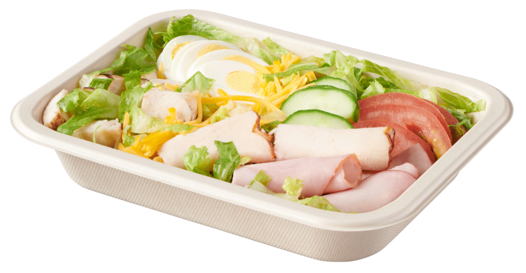 Single-compartment compostable salad tray with chef salad of lettuce, vegetables, sliced egg, cheese, chicken, turkey and ham.