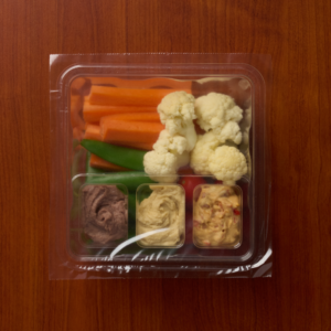 Sealed meal tray containing a balanced single-serve meal with compartments.
