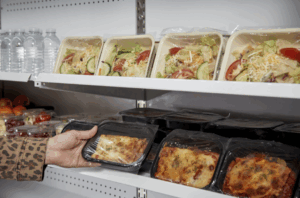Grab and go section with ready-made food in eco-friendly meal trays and films, including compostable and recycled plastic options.