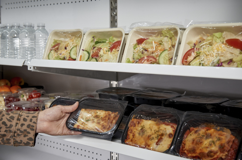 Grab and go section with ready-made food in eco-friendly meal trays and films, including compostable and recycled plastic options.
